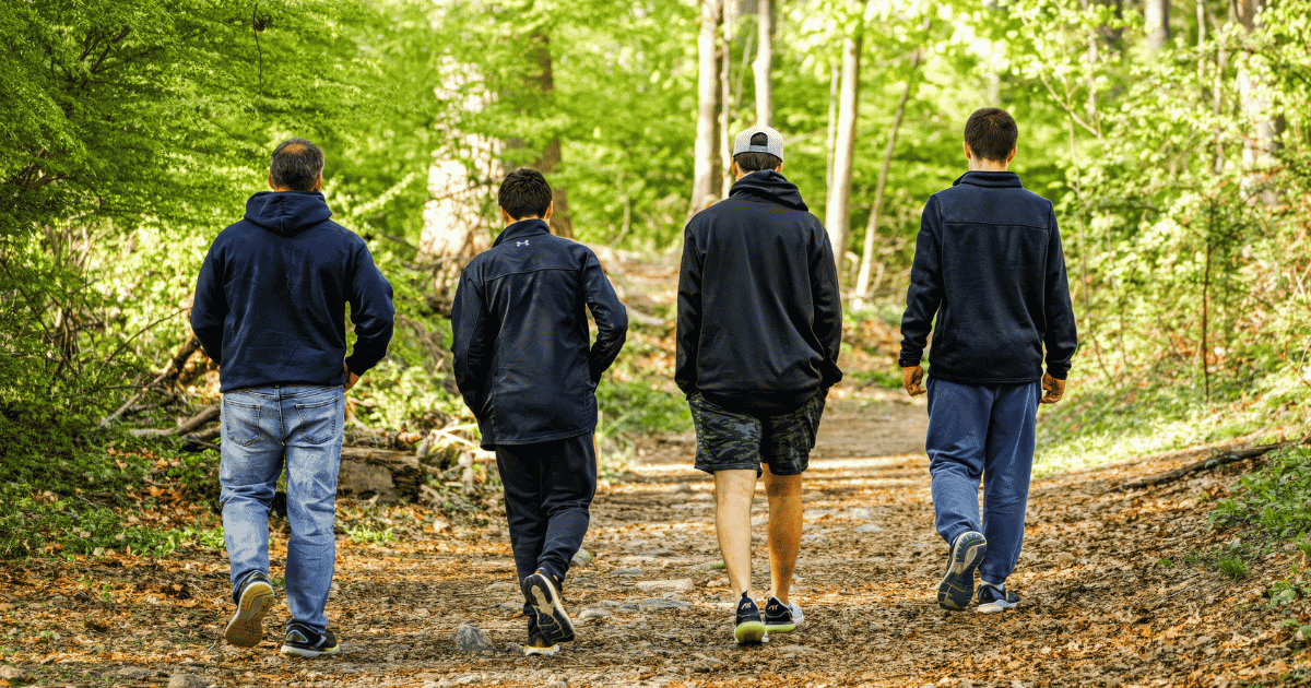 Four men walking outside