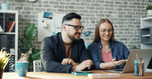 Man and woman sitting at a computer