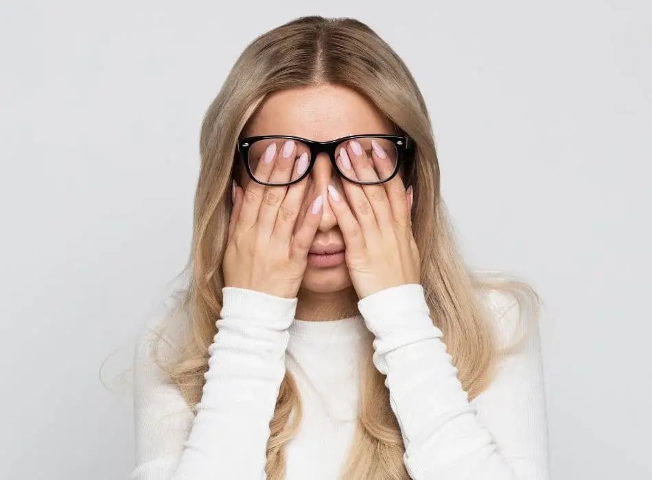 woman rubbing eyes