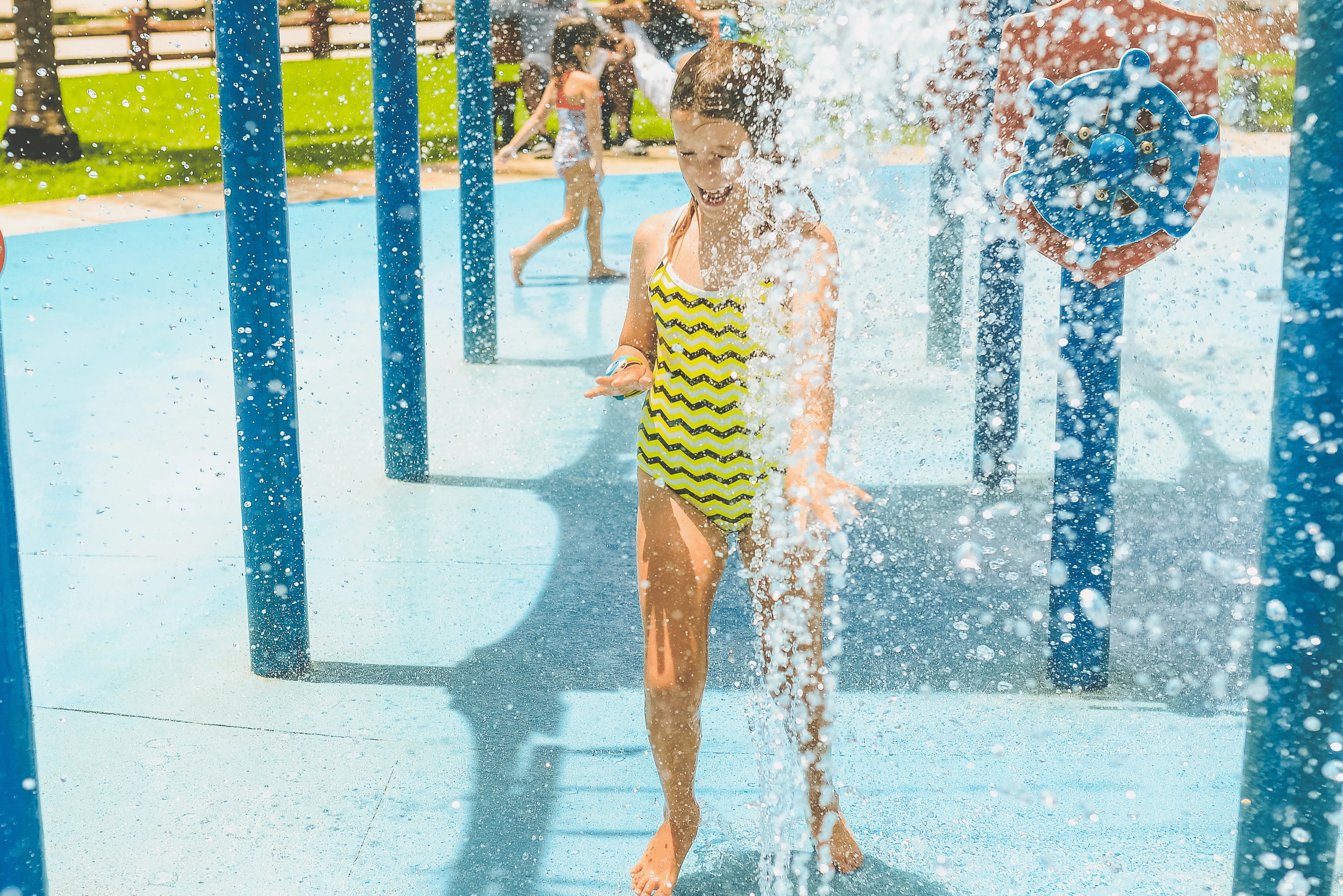 girl on splash pad having fun