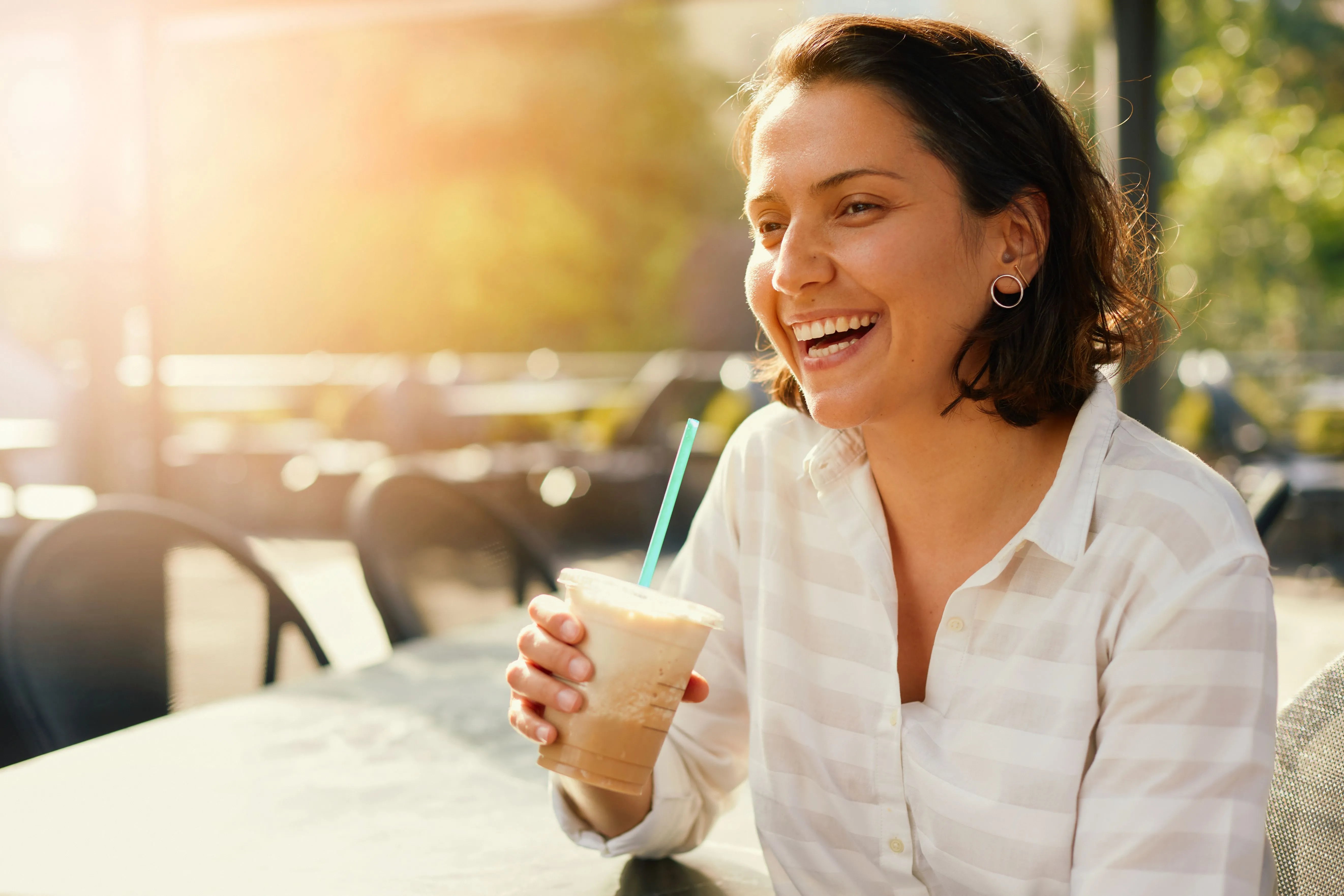 woman drinking iced coffee