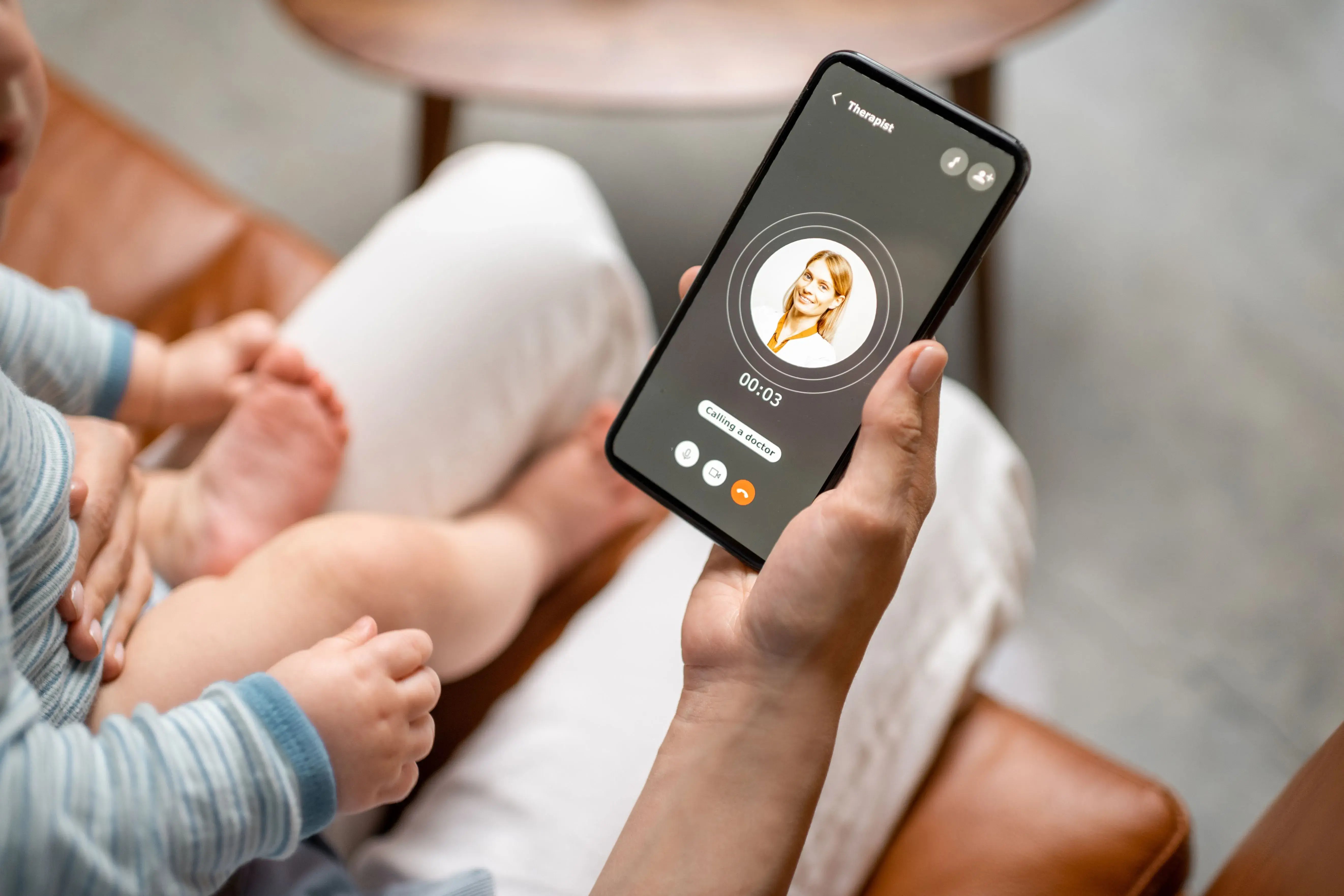mother on virtual telemedicine appointment for baby