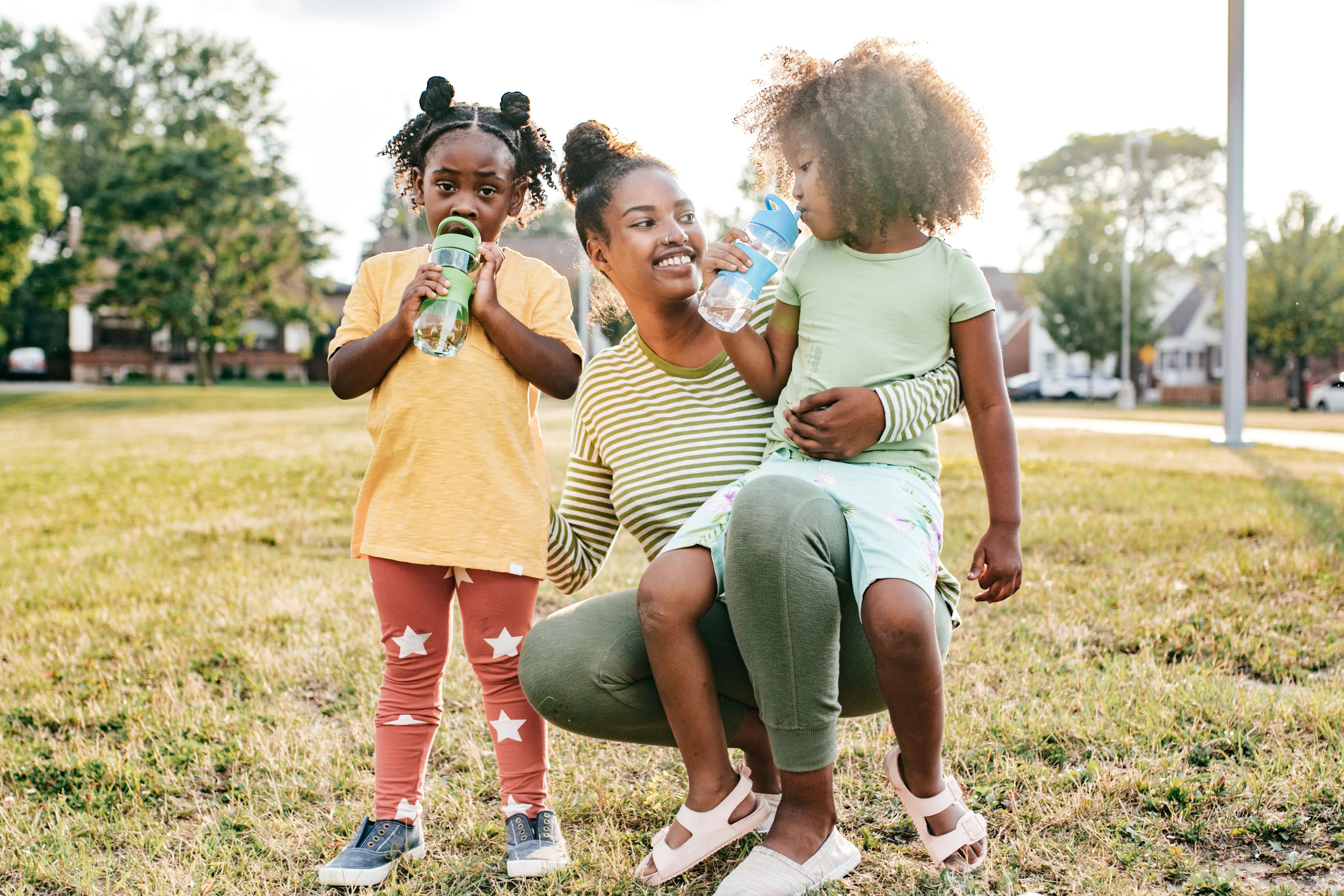 mom with daughters drinking water