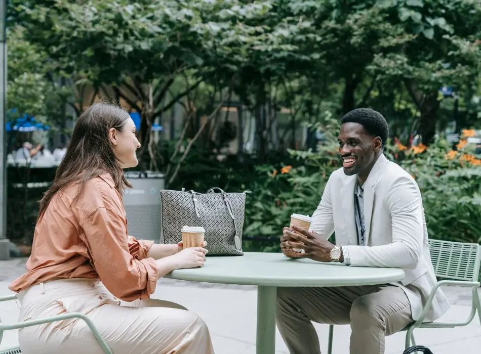 man and woman outside at table