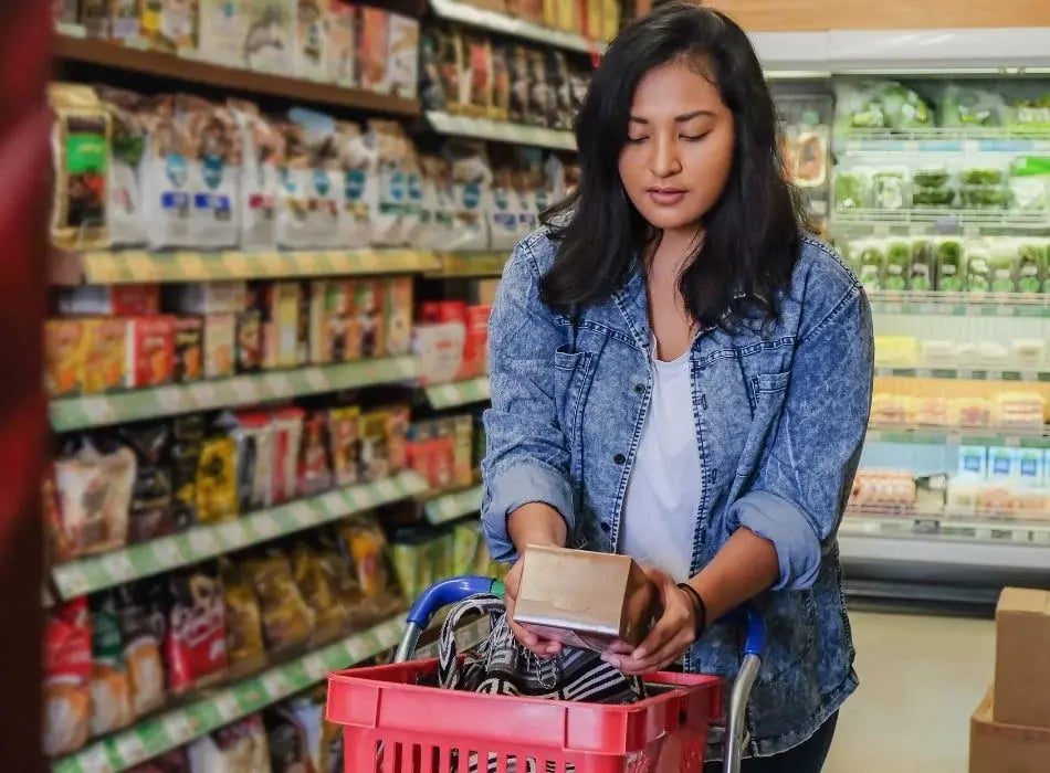 woman reading nutrition label