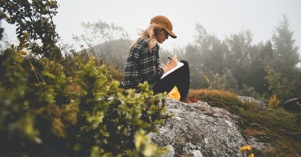 Woman journaling out in nature